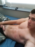 Young gay is wanking off his cock on th bed
