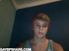 Toned blonde twink in hat shows off his abs