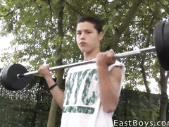 Cute teen gay is lifting weight before fondling his dick