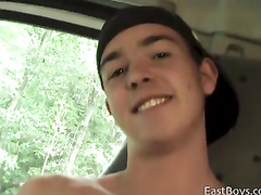 Smiling boy in cap is jerking off his cock