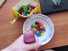 Naughty teen fag is jerking off his dick and cumming on m&m's bawl